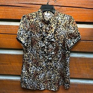 Women’s short sleeve leopard print button down blouse with high neck.